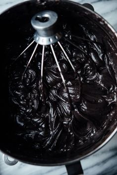 chocolate cake batter being whisked in a saucepan