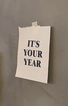 a piece of paper with the words it's your year written on it hanging on a wall