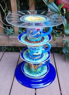 a stack of plates sitting on top of a wooden table