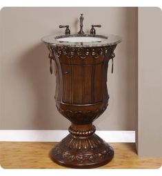 an ornate pedestal sink with marble top