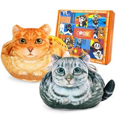 two stuffed animals sitting next to each other in front of a puzzle book and an orange cat