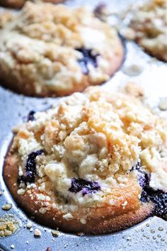 blueberry muffins with crumbs in a baking pan