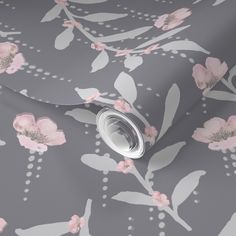 a grey and pink floral wallpaper with white dots on the bottom half of it