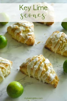 key lime scones with icing and limes on a marble countertop next to lemons