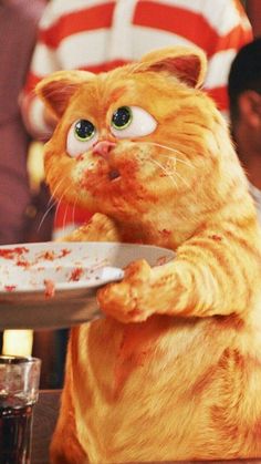 an orange cat standing on its hind legs and holding a plate with food on it