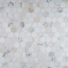 a white marble tile with hexagonal design