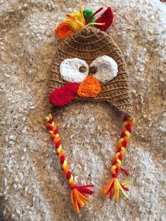 a crocheted turkey hat on top of a pile of carpet