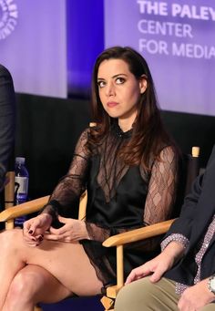 a woman sitting in a chair next to a man at a panel for the paley center for media