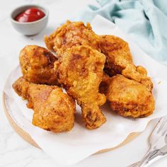 fried chicken on a plate with ketchup and sauce