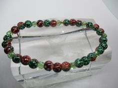 #2723 Handmade, Hand Beaded Stretch Red & Green Bracelet..7-7 3/4".. $6 plus $4 postage on orders under $20 ..This item and items for the entire family can be found at my website www.charmedbycharmsbycindy.com Stop over and visit and see all my amazing items that I have for sale.. Thanks !!! Green Bracelet, Ornament Wreath, 7 And 7, Red Green, Beaded Bracelets