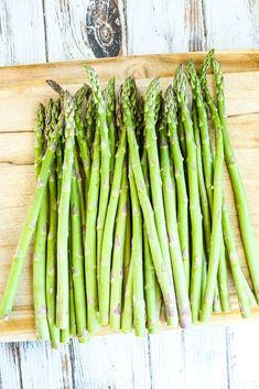 asparagus spears on a wooden cutting board