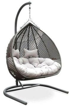 a hanging swing chair with pillows on the back and seat cushion in grey, black or white