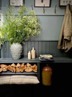 there is a table with some bread on it next to a potted plant and bottles