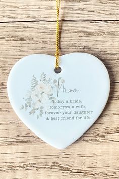 a ceramic heart shaped ornament with a poem on the front saying mom today a bride, tomorrow a wife, forever your daughter and best friend for life