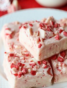 three pieces of white chocolate with red sprinkles stacked on top of each other