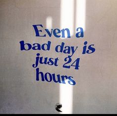 there is a sign that says even a bad day is just 24 hours on the wall