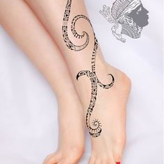 a woman's foot with an intricate tattoo design on the bottom of her leg