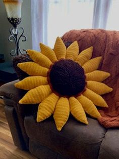 a sunflower is sitting on the back of a couch