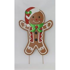 a gingerbread man with a santa hat and scarf on it's head is standing in front of a white background