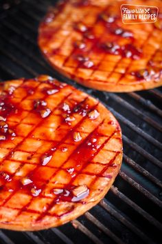 grilled ham steaks with bbq sauce on top and the grill in the background