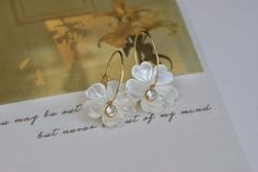 Material: 14k Gold filled Beads: White Mother of Pearl Flower size: 20mm Earring hoop diameter : 2cm Flower Shaped Hoop Earrings For Anniversary, Elegant Round Hoop Earrings With Flower Charm, Elegant Small Hoop Flower Earrings As Gift, Red Garnet Earrings, Flower Hoop Earrings, Bridesmaid Gifts Earrings, Earring Hoop, Gold Filled Hoops, Baroque Pearl Earrings