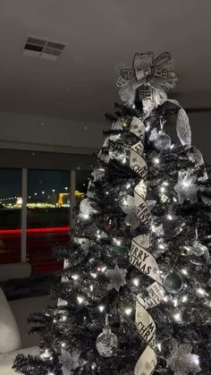 a black and white christmas tree decorated with ribbons