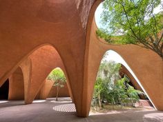 an arch shaped building with trees in the background