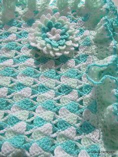 a crocheted blanket with flowers on it