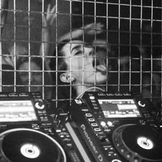 a man with headphones on in front of some dj equipment