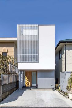 the house is white and has an open front door on one side, while the other half