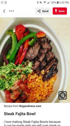 a bowl filled with meat, rice and veggies on top of a table