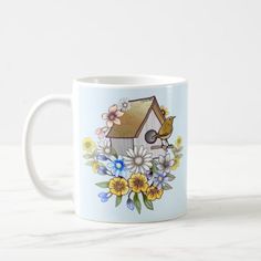 a coffee mug with flowers and a bird on it