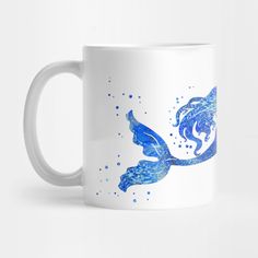 a white coffee mug with blue watercolor mermaid silhouettes on the front and bottom