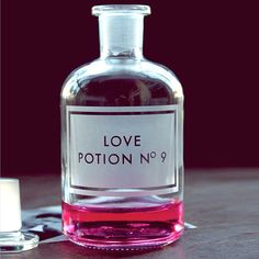 a bottle of love potion no 9 sitting on a table