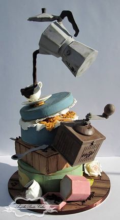 a cake made to look like a coffee pot pouring tea into a cup on top of it