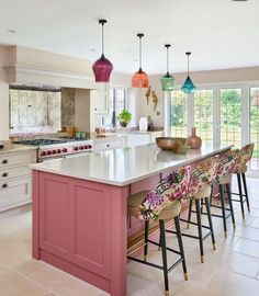 a large kitchen with an island in the middle and lots of stools around it