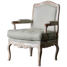 an old white chair with striped upholstered back and arm rests against a white background