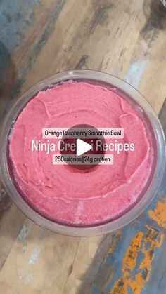 a bowl filled with pink food on top of a wooden table