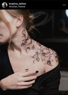 a woman with a flower tattoo on her chest