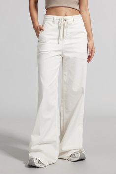 Carefully selected high-quality raw cotton, with clear twill, soft and comfortable touch, fresh white tone, easy to wear and match. Elastic high-waisted design offers relaxed comfort, interpreting a casual sports style. The back York lines design enhances the buttocks and shapes the body, highlighting the beauty of the female curves. Wide-leg pants release freedom of movement, exuding a cool and bold aura wherever you go.

Drawstring elastic waist
Refreshing white tone
Wide-leg fit

Product code: 6L1JJ7281000A50
Sizing


 Model wears size S and is 174cm/5'9" tall

Stats: Bust 83cm/32.6"+ Waist 61cm/24"+Hips 94cm/37" High Rise Cotton Bottoms For Elevated Casual Wear, Casual White Bottoms With Loosely Fitted Hips, White Stretch Bottoms With Drawstring, Trendy Cotton Drawstring Bottoms, High-rise Stretch Cotton Pants, Stretch High Rise Cotton Bottoms, Trendy Cotton Loungewear Bottoms, Comfortable White Bottoms With Loosely Fitted Hips, Trendy Cotton Bottoms For Loungewear