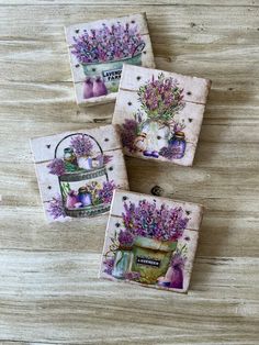 three coasters with flowers on them sitting on a table