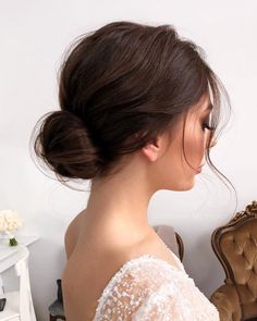 a woman with her hair in a low bun