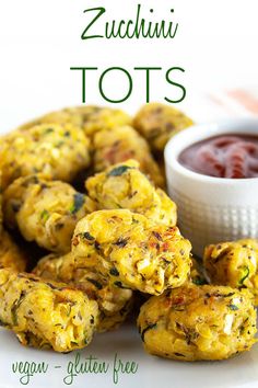 zucchini tots on a white plate with a small bowl of ketchup