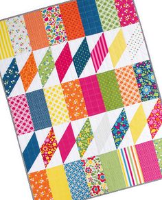 a multicolored patchwork quilt on white background