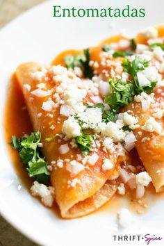 a white plate topped with ravioli covered in feta cheese and garnished with parsley