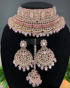 This elegant and gorgeous choker with matching earrings and tikka is sure to be a hit for any event! The neutral colors can match any outfit and the colors are perfect for any summer occasion! It comes in 3 beautiful tones with a pastel pink, mint and grey finish. The colors are versatile and can pair with any outfit and it's a complete set that can be work with/without the necklace! Indian Pink Jewelry, Pink And Silver Indian Jewelry, Pink Desi Jewelry, Pink Bridal Jewelry Sets, Pink Jewelry Set Indian, Indian Bride Jewelry Set, Pink Jwellary Set, Pink Bridal Jewellery, Pakistani Jewelry Sets