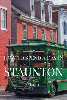 a green trolley car driving down a street next to tall red brick buildings with the words how to spend a day in stauton, virginia