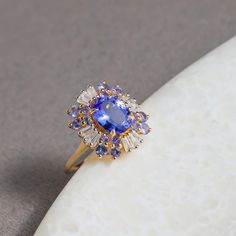 a tan and blue ring sitting on top of a white object