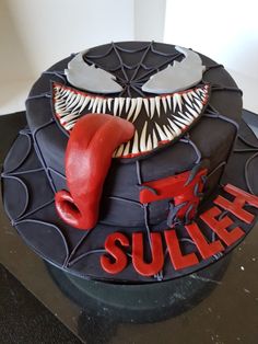 a cake decorated to look like a mouth with fangs on it's face and the word suller spelled out in red