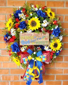 a colorful wreath is hanging on a brick wall